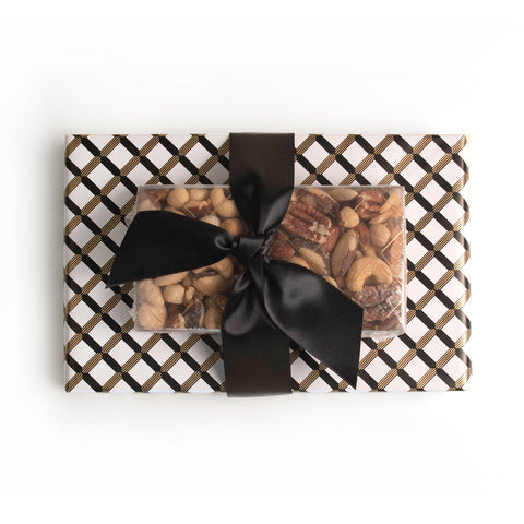 Black, gold and white wrapping paper. Tied with a satin black ribbon 