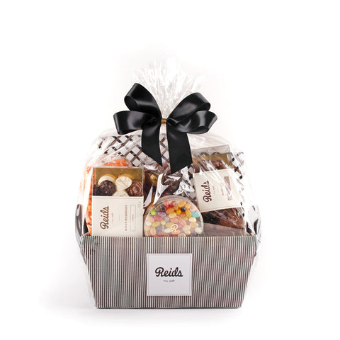 The medium basket comes in a black and white pinstriped basket wrapped in cellophane and tied with a bow
