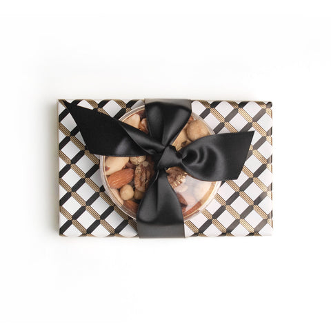 Black, gold and white wrapping paper. Tied with a satin black ribbon 