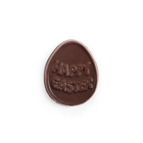 Solid chocolate molding in an egg shape with happy easter written on top.