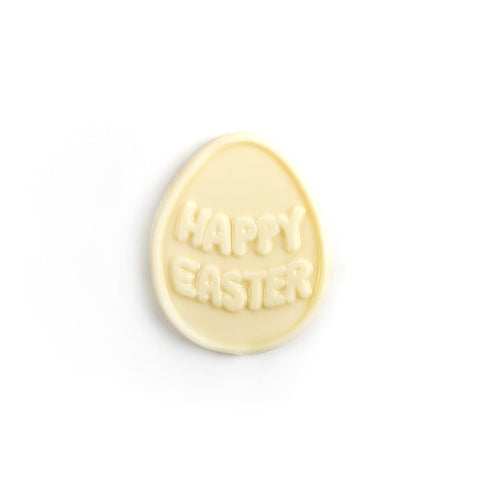 Solid chocolate molding in an egg shape with happy easter written on top.