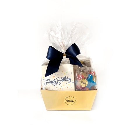 A basket filled with 100g assorted chocolates, 1/2 lb rosebuds and 1/2 bag of candy perfect to say Happy Birthday.