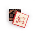 100 g of our classic assorted chocolates in a box with love is sweet text written on the top of it.