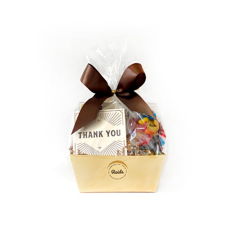 A basket filled with 100 g assorted chocolates, 1/2 lb rosebuds, and 1/2 lb bag of candy. Perfect to say Thank You.