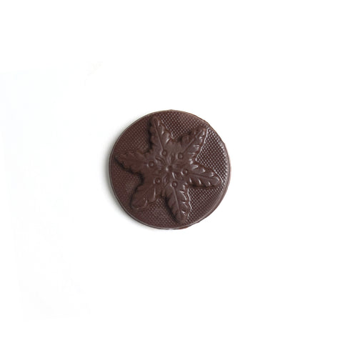 Product photo of dark chocolate snowflake mold. A round disk of chocolate with a snowflake.